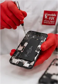 Close-up of a phone battery repair in progress