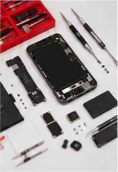 Phone parts and precision repair tools arranged on a workbench